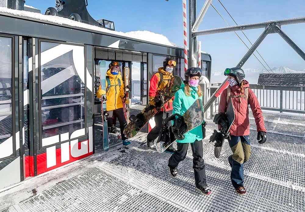 A group of skiiers getting off a ski lift