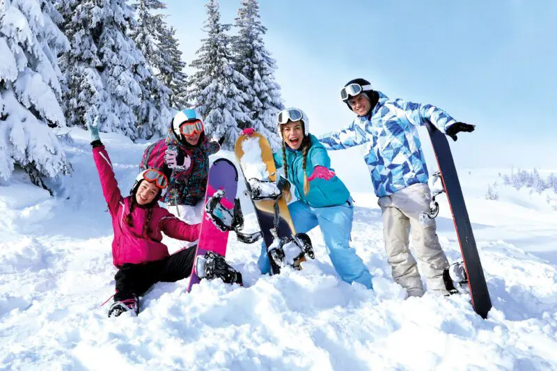 A group of friends enjoying ski lessons - find out more about ski extras and skiing equipment/snowboards